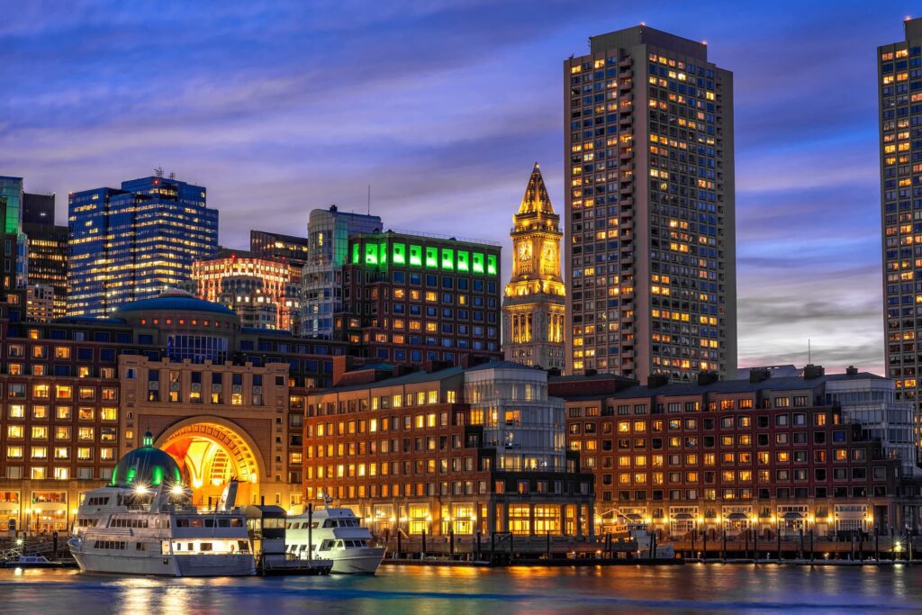 Boston Harbor with the downtown Boston skyline behind the waterfront.