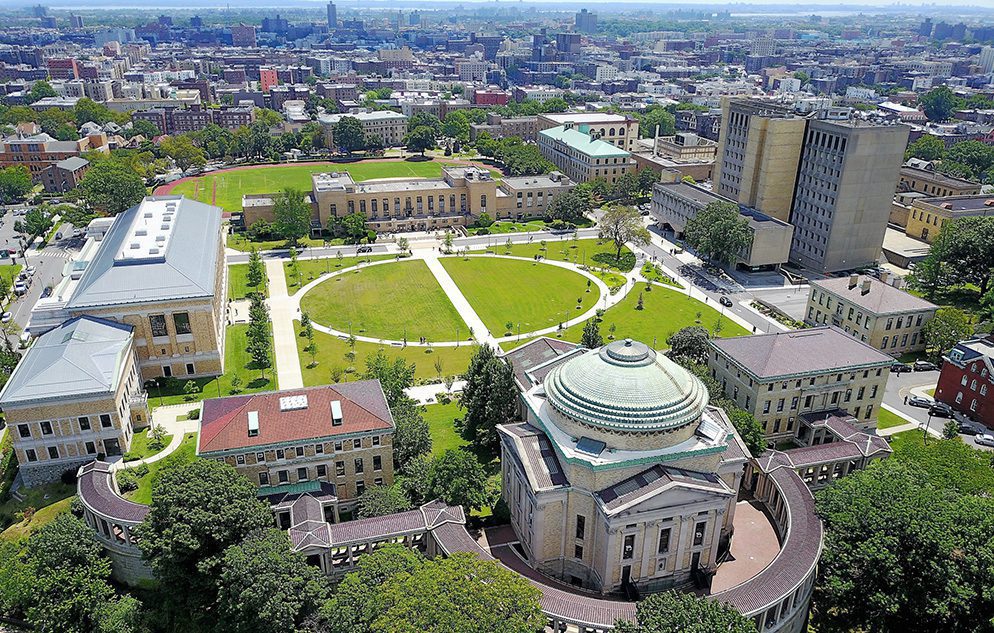 The colonnade of the Hall of Fame for Great Americans on the Bronx Community College campus, its arches framing the lawn beyond.