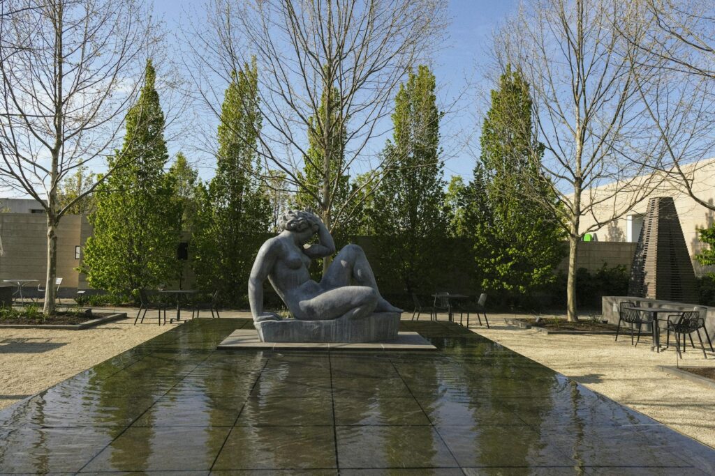 The Columbus Museum of Art's courtyard, its glass-walled pavilion open onto tables and a low fountain.