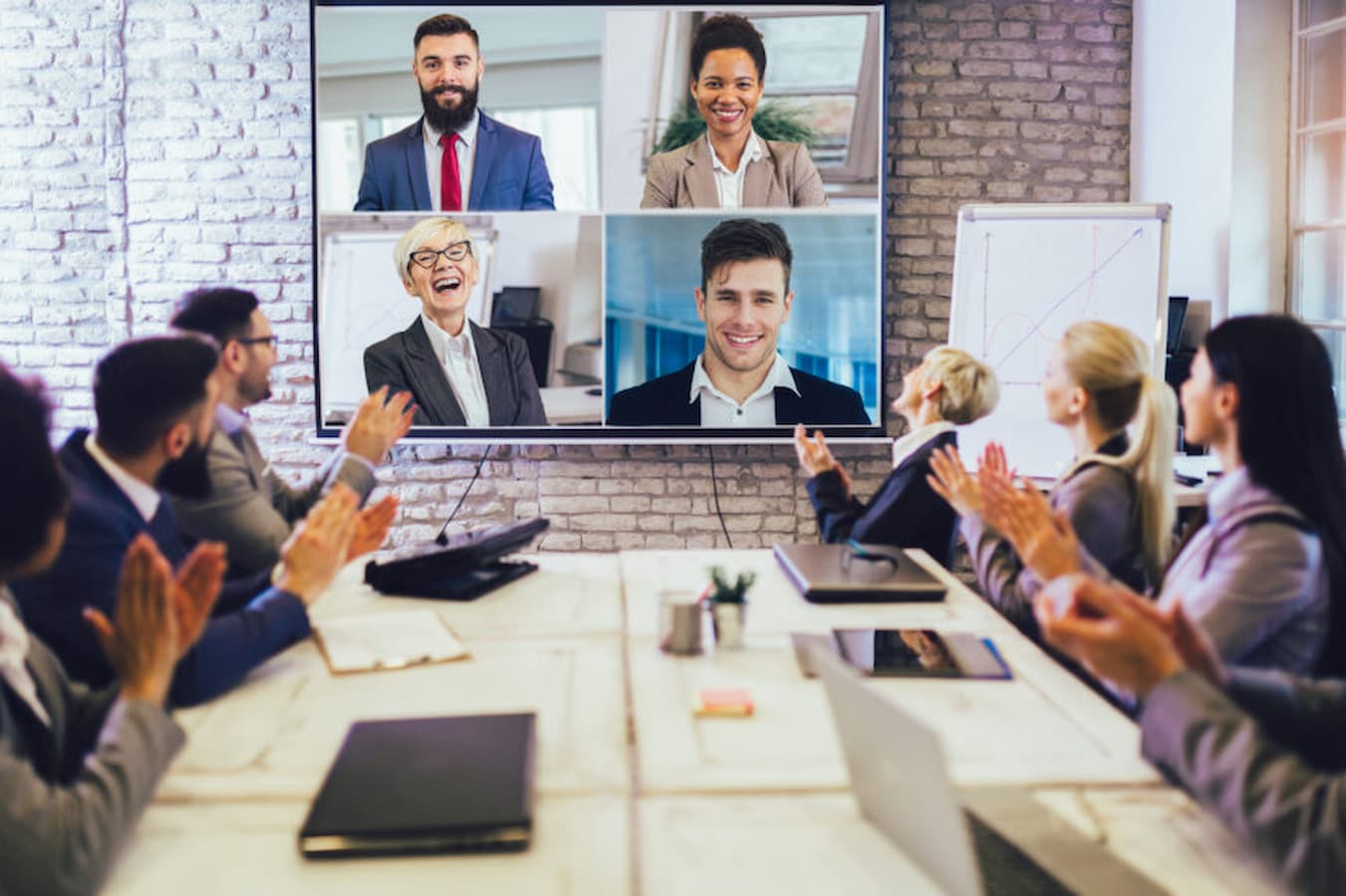 Business people looking at a screen during a video conference in the conference room