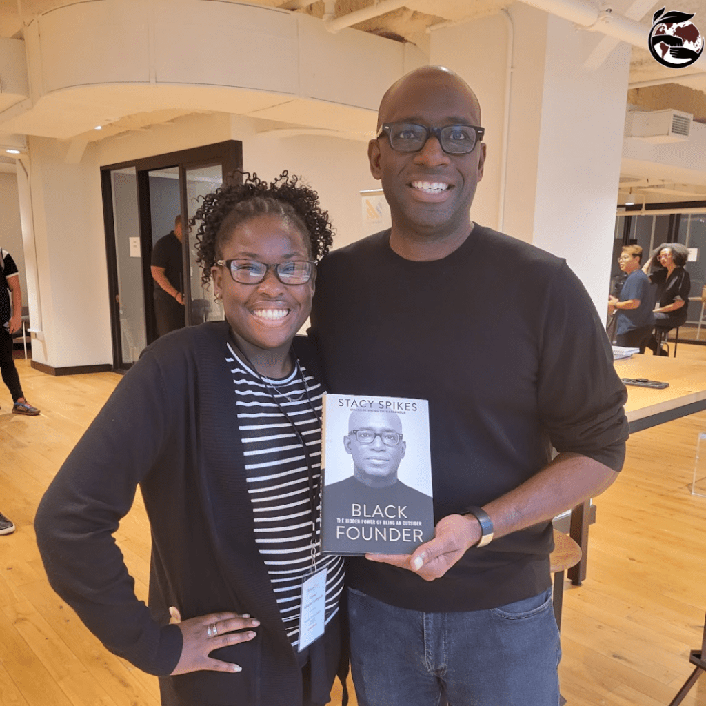 At the FutureCast event holding the book on Black Founder by Stacy Spikes